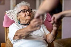 Elderly lady being helped up